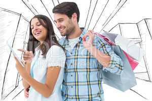 Composite image of happy couple with shopping bags and tablet