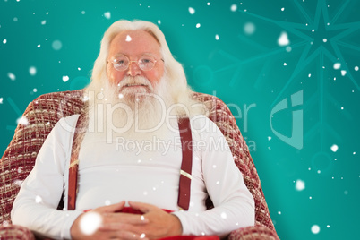 Composite image of father christmas sitting on the armchair