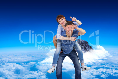 Composite image of man giving girl a piggy back