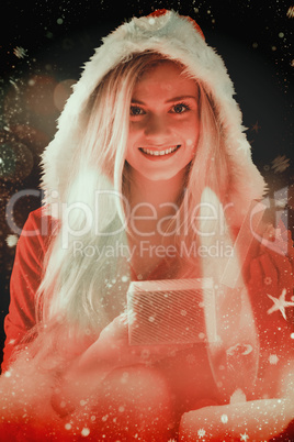 Composite image of pretty blonde in santa outfit opening gift