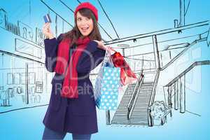 Composite image of brunette holding shopping bags and credit car