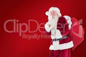 Composite image of santa asking for quiet with bag