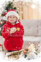 Composite image of festive little boy smiling at camera