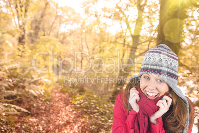 Composite image of cold redhead wearing coat and hat