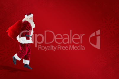 Composite image of santa claus carrying sack