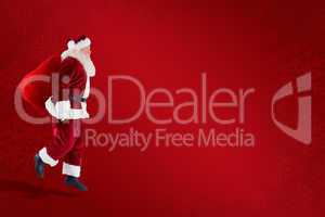 Composite image of santa claus carrying sack