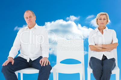 Composite image of upset couple not talking to each other after