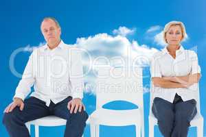 Composite image of upset couple not talking to each other after
