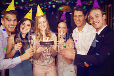 Composite image of attractive friends celebrating a birthday