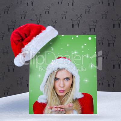 Composite image of pretty girl in santa outfit blowing