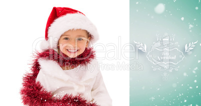 Composite image of cute little girl wearing santa hat and tinsel