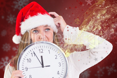 Composite image of festive blonde showing a clock