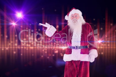 Composite image of santa shows something to camera