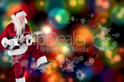 Composite image of santa claus has fun with a guitar