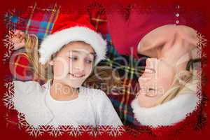 Composite image of festive mother and daughter smiling on blanke