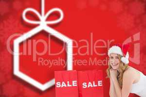 Composite image of festive blonde lying with sale shopping bags