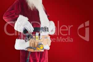 Composite image of father christmas is wearing a tool belt
