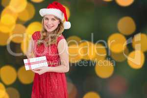 Composite image of blonde holding a christmas gift