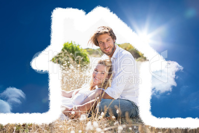 Composite image of attractive couple relaxing in the countryside