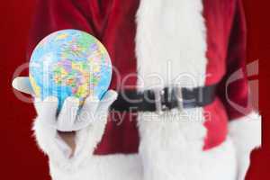 Composite image of santa has a globe in his hand