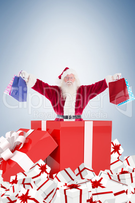 Santa standing in large gift