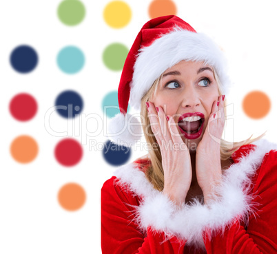 Composite image of festive blonde with hands on face