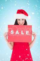 Composite image of festive brunette in red dress holding sale si
