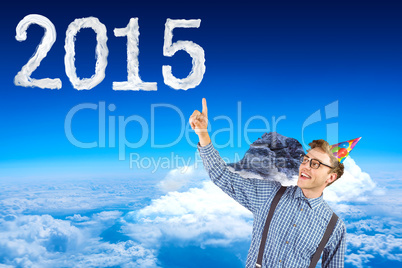 Composite image of geeky hipster wearing party hat pointing