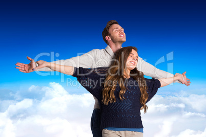 Composite image of romantic young couple with arms out