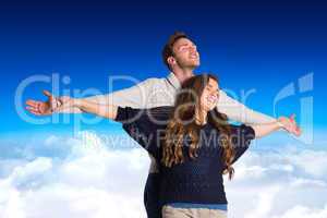 Composite image of romantic young couple with arms out