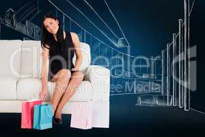 Composite image of woman sitting with shopping bags
