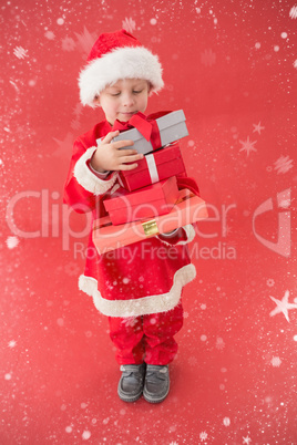 Composite image of cute little boy in santa costume