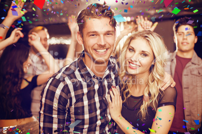 Composite image of stylish couple smiling and dancing together