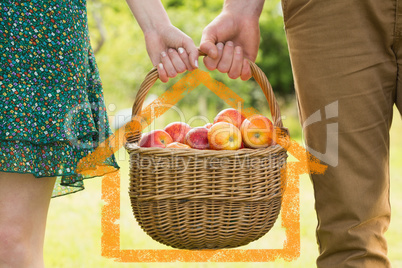 Composite image of basket of apples being carried by a young cou