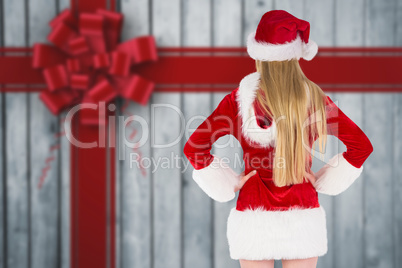 Composite image of festive blonde standing rear view Composite image of festive blonde standing rear view