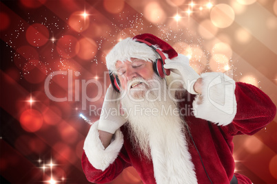 Composite image of santa claus enjoys some music