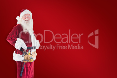 Composite image of father christmas is wearing a tool belt