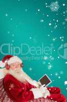 Composite image of father christmas listening to music with tabl