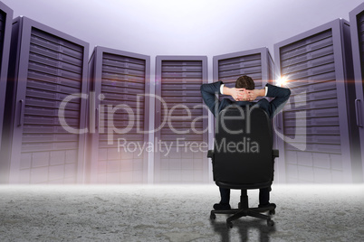 Composite image of businessman sitting in swivel chair