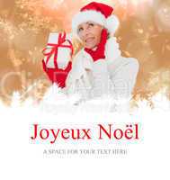 Composite image of festive woman holding gift