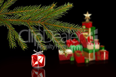 Composite image of red christmas decoration hanging from branch