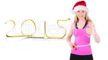 Composite image of fit festive young blonde measuring her waist