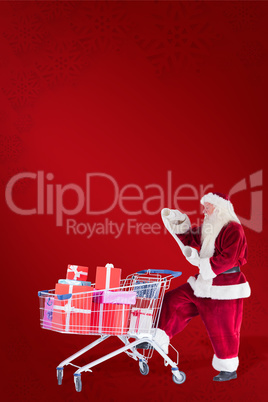 Composite image of santa pushes a shopping cart while reading