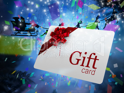 Composite image of santa flying his sleigh behind gift card