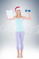 Festive fit blonde holding page and dumbbell