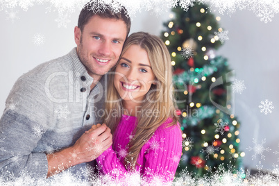 Composite image of smiling couple sitting together