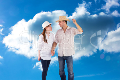 Composite image of smiling couple both wearing hats