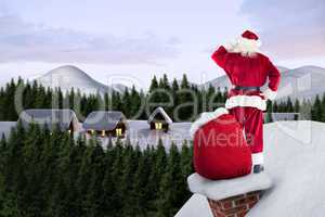 Composite image of santa on cottage roof