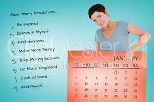 Composite image of smiling woman pointing at calendar on a panel