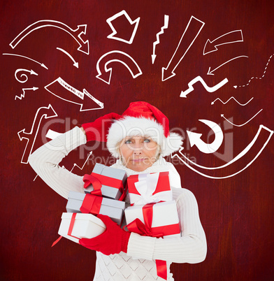 Festive woman in santa hat holding gifts